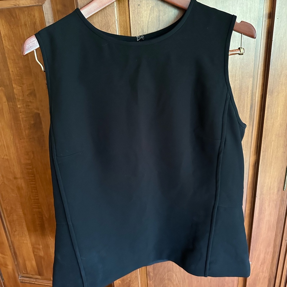 Sleeveless black top.